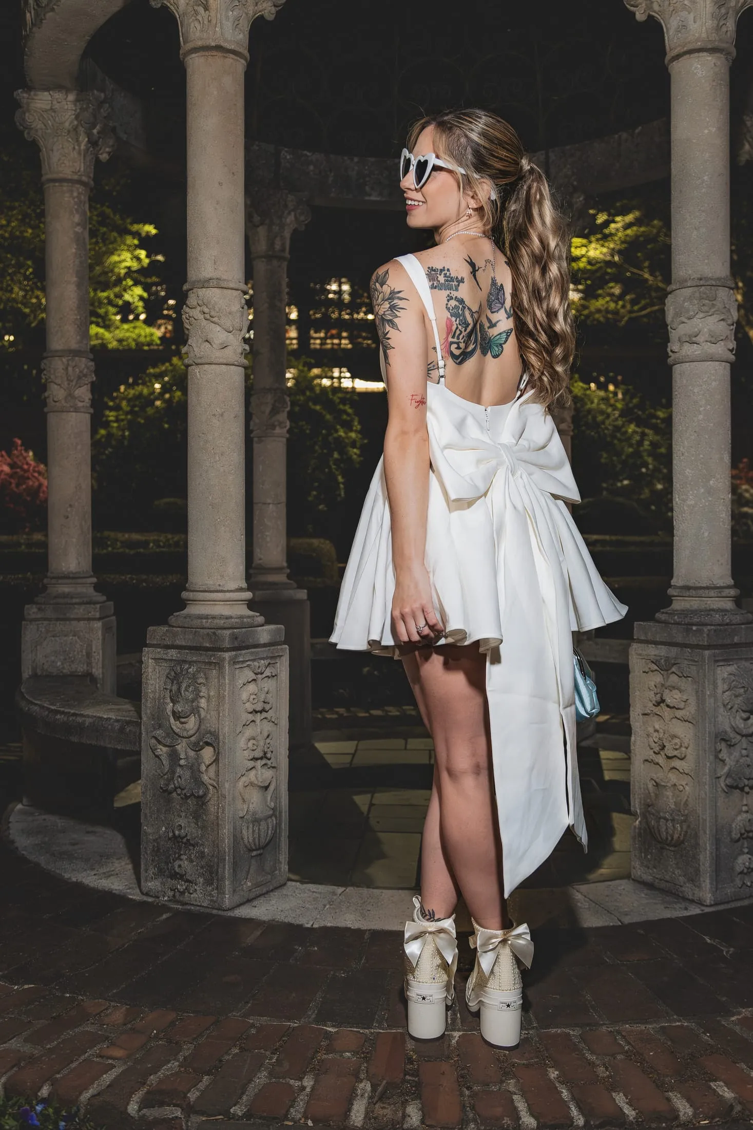 Bride lacing up a custom bridal sneaker.